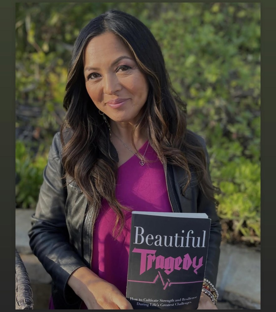 Judy Thureson holding her book, Beautiful Tragedy